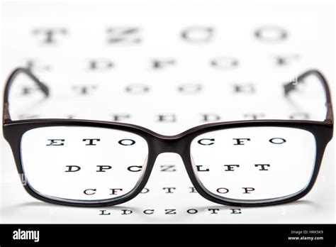 Glasses On A Eye Exam Chart To Test Eyesight Accuracy Stock Photo Alamy