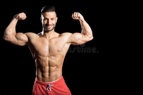 Young Bodybuilder Flexing Muscles Isolate On Black Blackground Stock