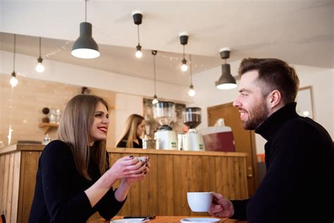 Premium Photo Young Couple Talking In A Coffee Shop