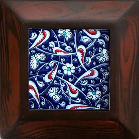 A Blue And White Tile In A Wooden Frame