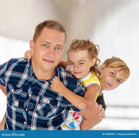 Mom and Daughter Look Out from Behind Dad Stock Image - Image of club
