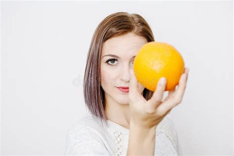 Woman Holding An Orange Orange On The Girl`s Head Stock Photo Image