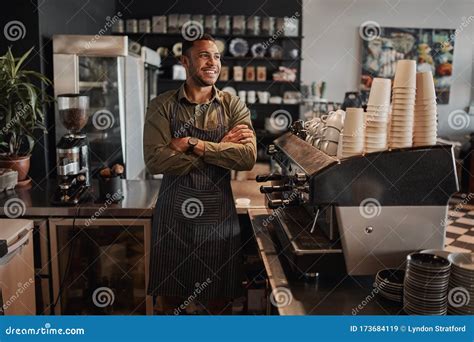 Thoughtful Afro American Small Coffee Shop Owner Standing Behind