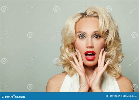 happy exsited surprised woman with blonde curly hair and makeup on white background stock image