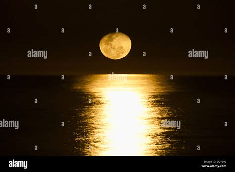 Full Moon Reflecting At Sea At Night Stock Photo Alamy