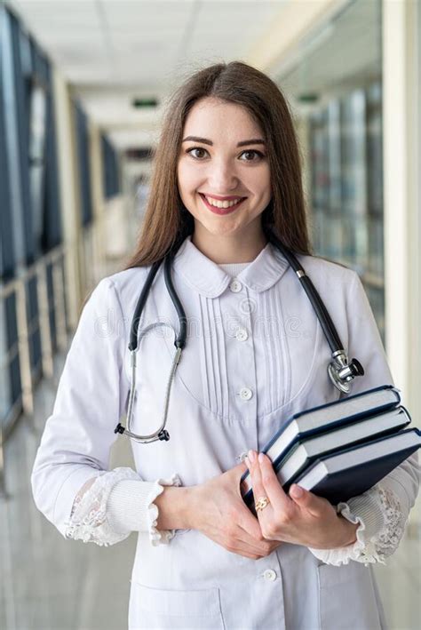 Female Doctor Holding Book Or Magazine And Walking Down The Med