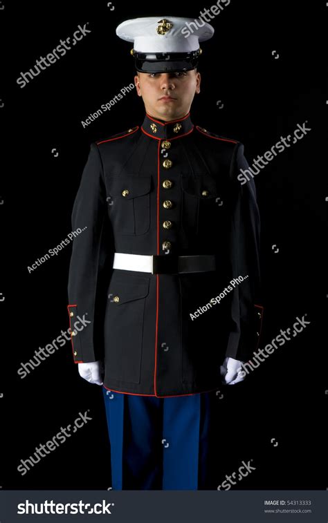 A United States Marine Wearing Dress Blues In A Studio Environment