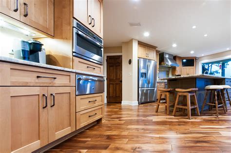 Clear alder with natural finish. Woodharbor perimeter cabinetry features Chelsea door style, Manor Flat drawer front in Alder ...