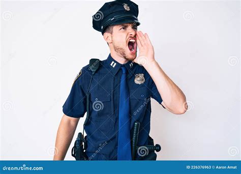 Young Caucasian Man Wearing Police Uniform Shouting And Screaming Loud