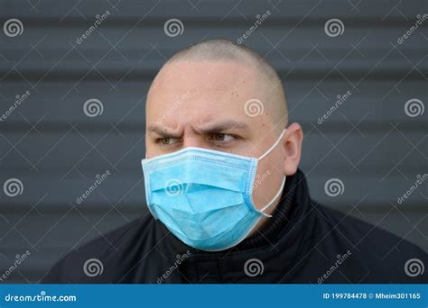 Angry Young Man Wearing A Surgical Face Mask Stock Photo Image Of