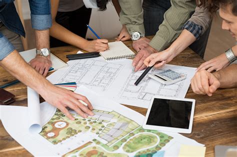 Architect Team Discussing On Blueprints Stock Photo Download Image