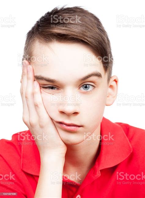Bored Teen Boy With Head On Hand Isolated On White Stock Photo