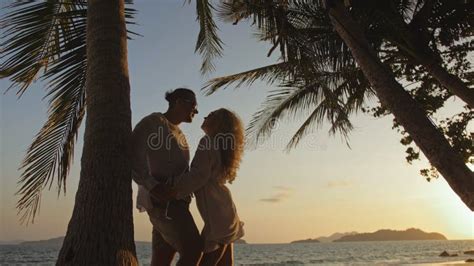 Loving Couple Near Palm Tree Kissing Hugging Relax And Drinki Stock