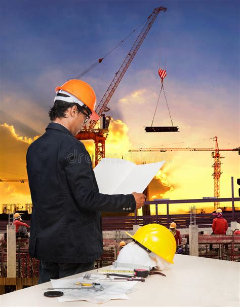 Engineering Man Working In Building Construction Site Against Be Stock