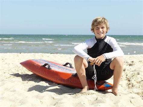 Portrait Of Confident Boy Nipper Child Surf Life Savers Sitting On