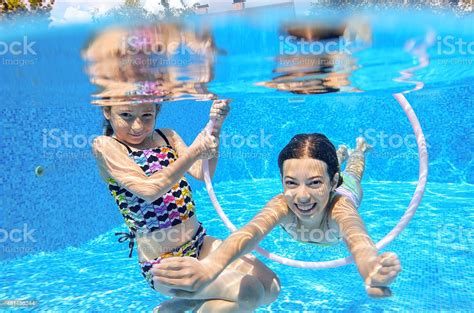 Happy Children Swim In Pool Underwater Girls Swimming Stock Photo