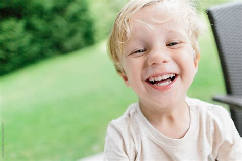 Cute Little Boy Laughing In Yard By Stocksy Contributor Amir