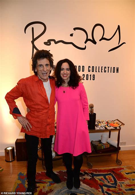 Ronnie Wood Playfully Attempts To Scribble On His Stunning Wife Sally At Art Event