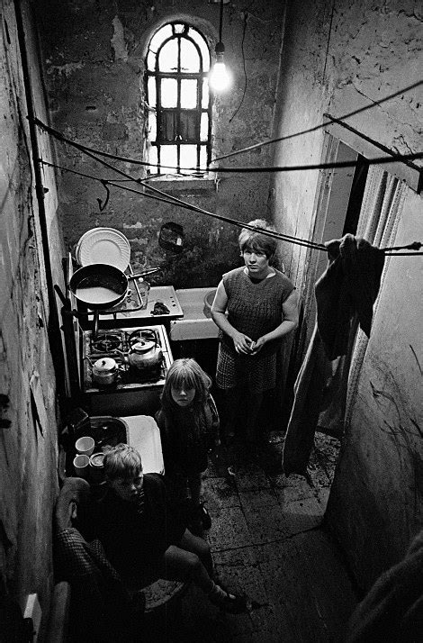 Slum Britain Children Playing In Rags And Families Huddling In Cellar