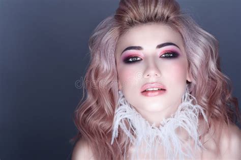 Beautiful Young Model With Colorful Artistic Make Up And Wavy Hairstyle