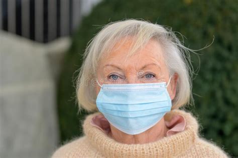 Attractive Senior Lady Wearing A Disposable Mask Stock Photo Image Of