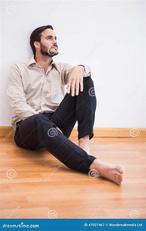 Casual Thoughtful Man Leaning Against Wall Looking Up Stock Image