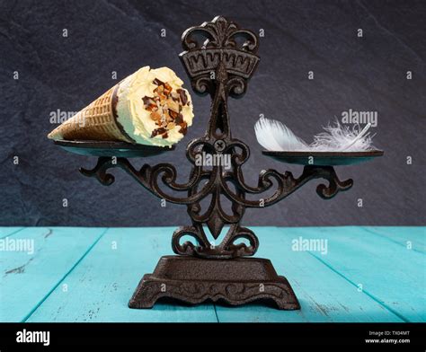 Ice Cream Cone And Feather On A Balanced Scale Concept Of Non Fat Ice