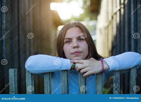 Young Happy Teen Girl Posing Near The Fence In The Village Stock Photo