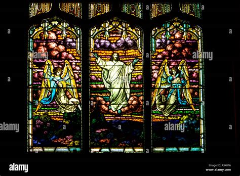 Stained glass window of Jesus Ascending up to heaven with angels on