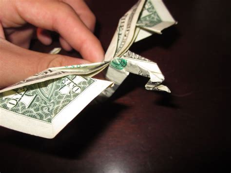 Someone Is Folding Up Dollar Bills On Top Of Each Other To Make An
