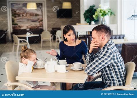 Couple Fighting In Front Of Child At Cafe Or Restaurant Royalty Free