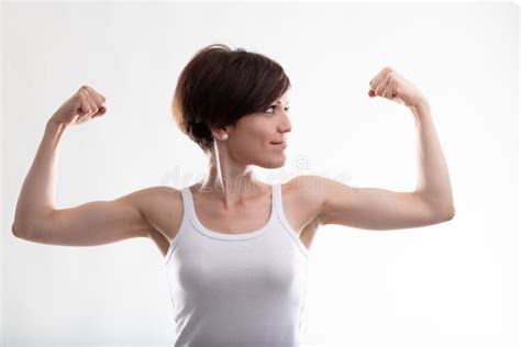 Young Woman Flexing Her Arms For Showing Her Biceps Muscles Stock Image