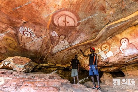 Aboriginal Guides Presenting Wandjina Cave Artwork In Sandstone Caves
