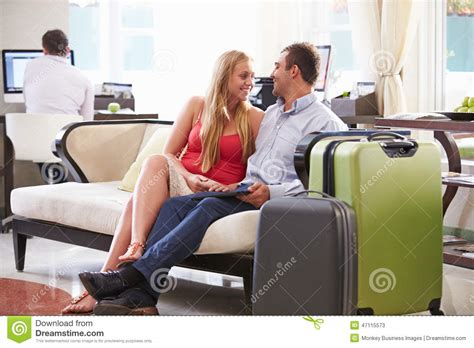 Couple Sitting In Hotel Lobby With Luggage Stock Image Image Of Vacation Luxury 47115573