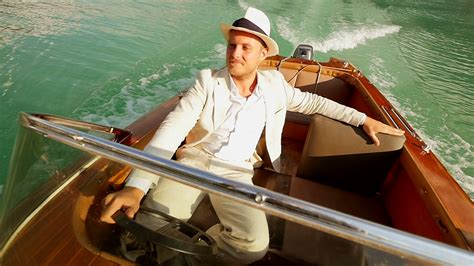 happy man enjoying life ridding boat over lake. raised hands. carefree ...