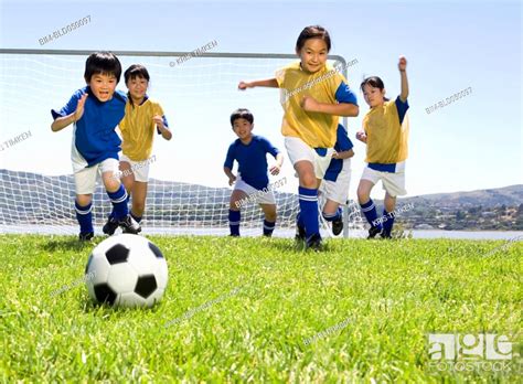 Multi Ethnic Children Playing Soccer Stock Photo Picture And Royalty
