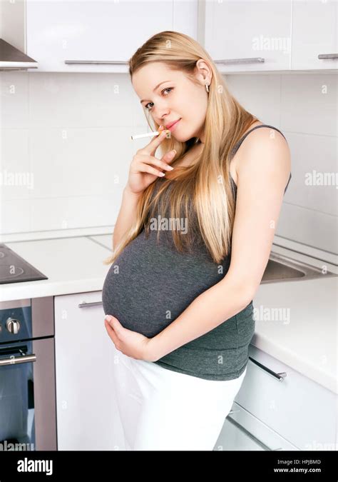 Pregnant Woman Smoking Cigarettes At Home Stock Photo Alamy