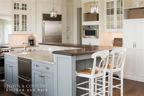 While the size of your space will ultimately determine if a kitchen island with seating will work, even the coziest kitchen might be able to accommodate an island with enough. Stunning white and blue cottage kitchen features white ...