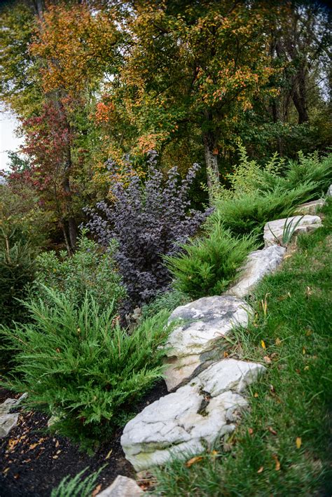 Adding Boulders To A Hillside Blends Right Into Your Gardens