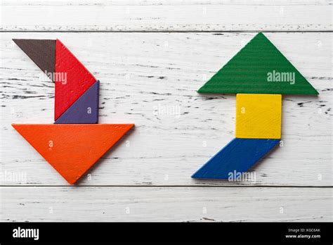 Wooden Tangram In Two Arrow Shapes One Is Up And The Other Is Down