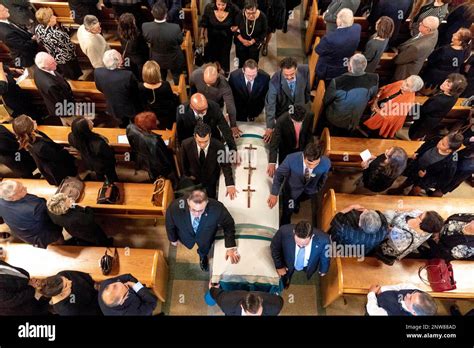 Family and friends pay respect during the funeral mass for former Rep