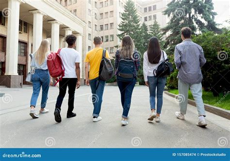 Students Walking Together Outdoors After Studies In Campus Stock Photo