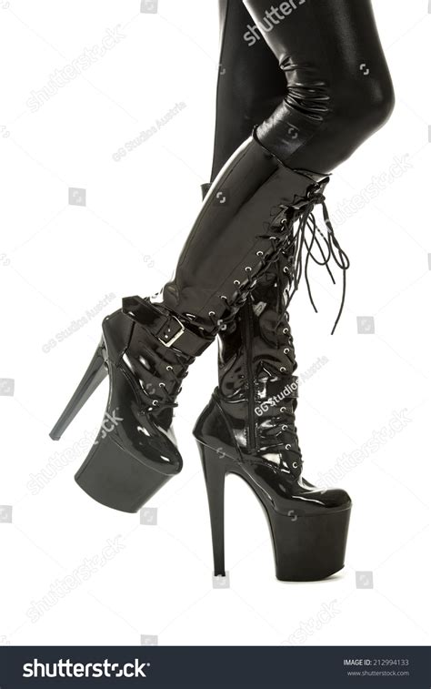 Legs Of A Woman In Fetish Wear Latex Stockings With Garter Belt And High Heels Boots With