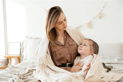 Cute Baby Girl And Her Mom Enjoy The Morning At Home In The Bedroom