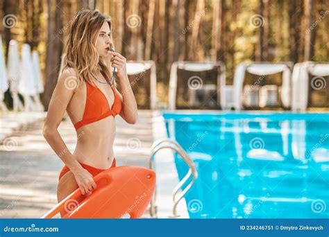 A Blonde Lifeguard In The Pool Whistling And Looking Serious Stock Image Image Of Leisure