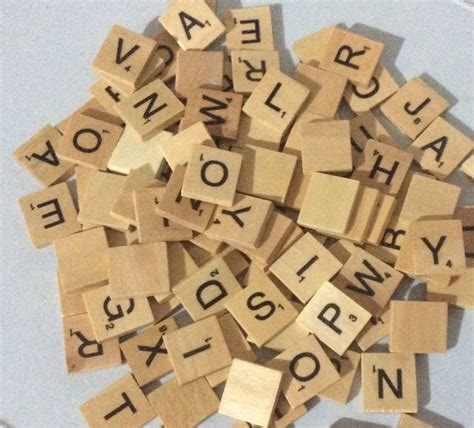 Several Wooden Scrabbles With Letters And Words On Them Sitting In A Bowl