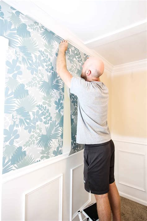 Once you get the piece you cut and ready to go you holding the sticky edge of the paper straight evenly place the paper close the ceiling or crown molding. How to Hang Peel & Stick Wallpaper