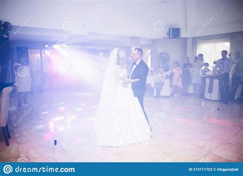 First Wedding Dance Of Newlywed Couple In Restaurant Stock Photo
