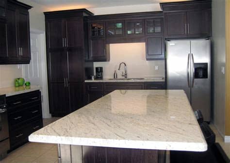 White kitchen cabinets with granite countertops can be chosen for all of you who have classic white house. River White Granite