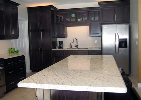 One great way to break up the use of white is with a dark colored countertop! River White Granite